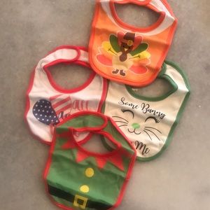 Set of four holiday baby bibs. NWT